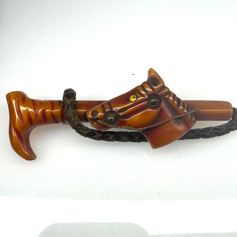 Red Butterscotch Bakelite Carved Horse Crop Brooch Pin Derby Art Deco Metal Eye